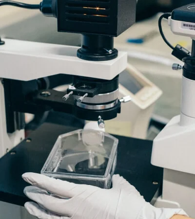 Biosafety training: gloved hands handling laboratory tools